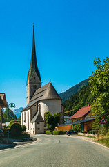 Fototapeta na wymiar Beautiful austrian church with a perfect cloudless blue sky