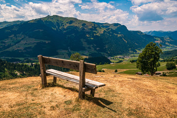 Beautiful alpine view with a bench at Aurach near Kitzb&uuml;hel, Tyrol, Austria
