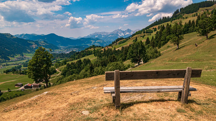Fototapeta na wymiar Beautiful alpine view with a bench at Aurach near Kitzbühel, Tyrol, Austria