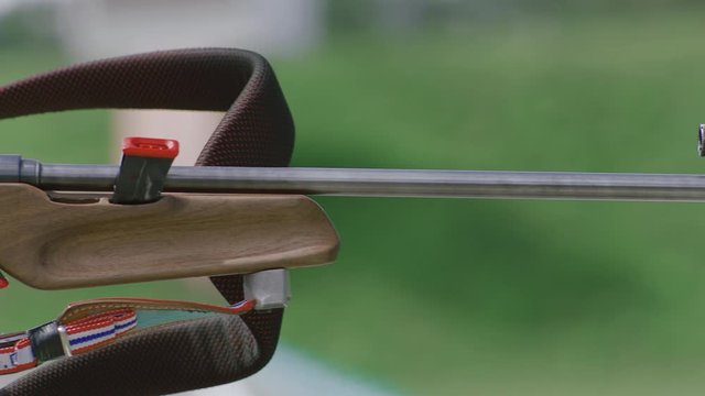Portrait of Caucasian female professional biathlete practicing on a shooting range during mid-season practice in summer. ARRI Alexa Mini with Cooke S4 prime lenses RAW graded footage