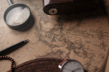 Fototapeta na wymiar Indonesia Map Between Traveler's Accessories on Old Vintage Map. Travel Concept Background.