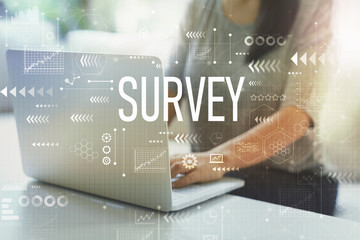 Survey with woman using her laptop in her home office