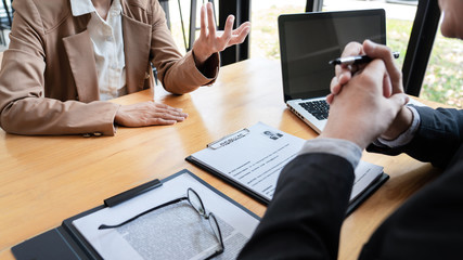 businessman candidate explaining about his profile and conducting a job to managers sitting in job Interview in modern office, consulting or employment concept.