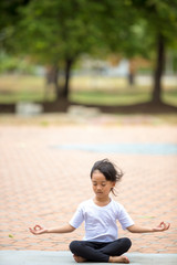 beautiful Asian children meditating in lotus position