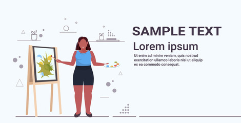 fat obese woman painter using paintbrush african american overweight girl artist painting on easel art creativity concept full length flat horizontal copy space