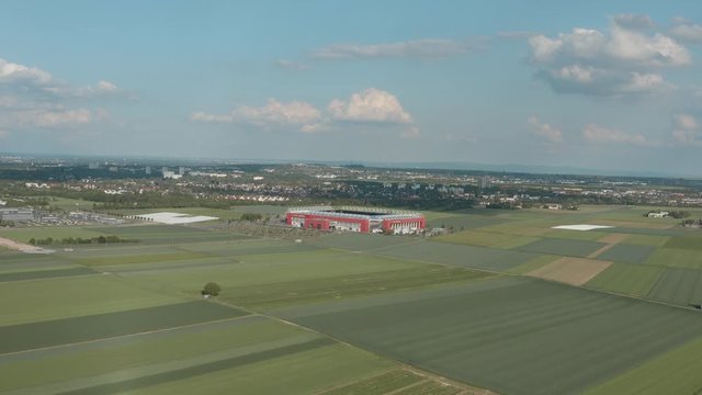 Drone / Aerial shot of the football stadium of the bundesliga team FSV Mainz 05 with field in the foreground on a sunny day, 30p