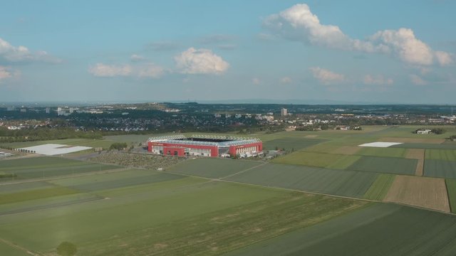 Drone / Aerial shot of the football stadium of the bundesliga team FSV Mainz 05 with field in the foreground on a sunny day, 30p