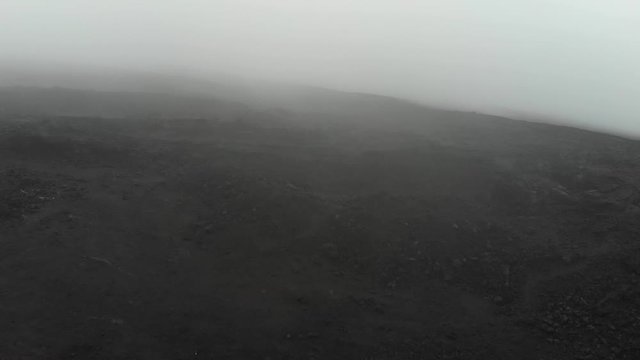 aerial of Mauna Loa lava fields at 10000 foot elevation through fog