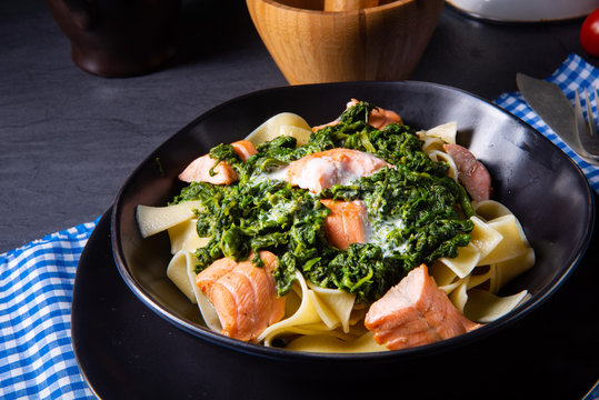 pappardelle pasta with creamed spinach and fried salmon