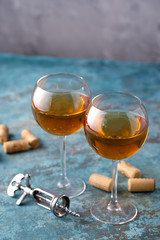 Two glasses with white wine on a textural background. Copy space. Place for your text.