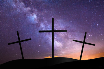 Three crosses on hill top with milky way in background