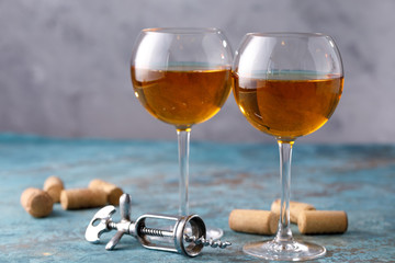 Two glasses with white wine on a textural background. Copy space. Place for your text.