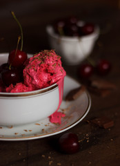 Homemade cherry ice cream on table
