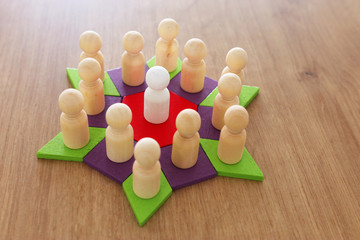 Obraz premium business concept image of tangram puzzle blocks with people figures over wooden table ,human resources and management concept