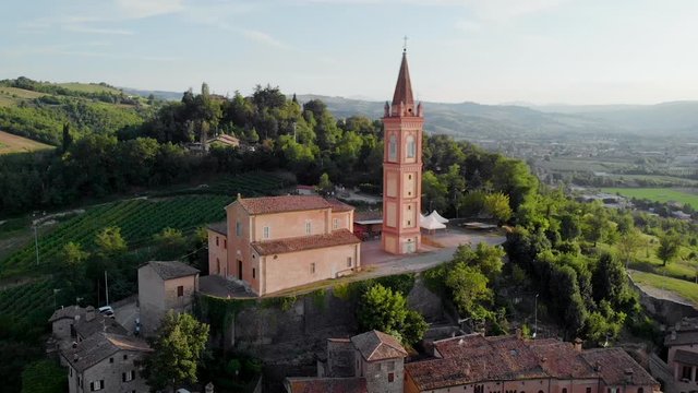 AERIAL Catholic Church in small town on the hill in Savignano  Emilia Romagna