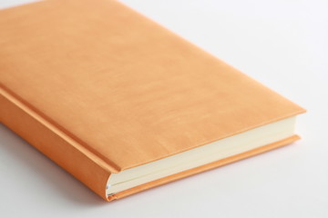 book with orange cover on colorful background