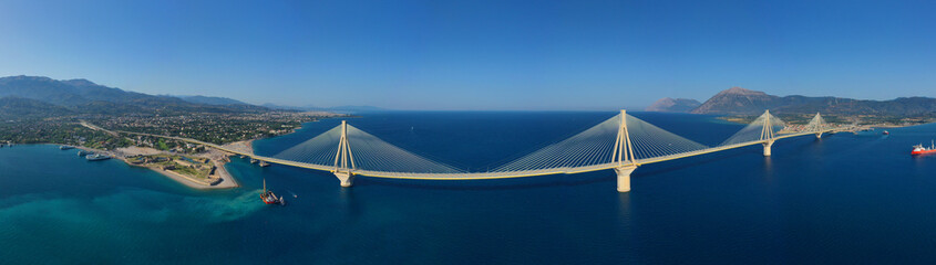 Aerial drone panoramic photo of world famous cable suspension bridge of Rio - Antirio Harilaos Trikoupis, crossing Corinthian Gulf, mainland Greece to Peloponnese, Patras