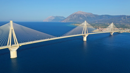 Aerial drone panoramic photo of world famous cable suspension bridge of Rio - Antirio Harilaos Trikoupis, crossing Corinthian Gulf, mainland Greece to Peloponnese, Patras