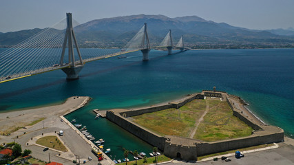 Aerial drone photo of iconic medieval castle of Antirio next to world famous cable suspension bridge of Rio - Antirio crossing mainland Greece to Peloponnese