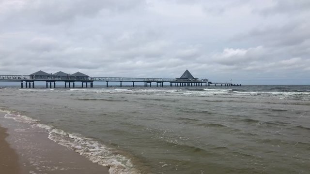 On the beach under the Heringsdorf Pier. Heringsdorf Pier is a pier located in Heringsdorf, with a length of 508 metres; stretching out into the Baltic Sea, on th