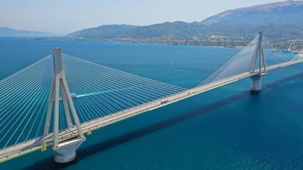 Aerial drone photo of world famous cable suspension bridge of Rio - Antirio Harilaos Trikoupis, crossing Corinthian Gulf, mainland Greece to Peloponnese, Patras