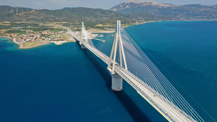 Aerial drone photo of world famous cable suspension bridge of Rio - Antirio Harilaos Trikoupis, crossing Corinthian Gulf, mainland Greece to Peloponnese, Patras - obrazy, fototapety, plakaty