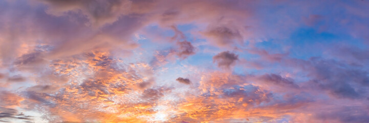 Naklejka na ściany i meble Dramatic vibrant color with beautiful cloud of sunrise and sunset on a cloudy day. Panoramic image.