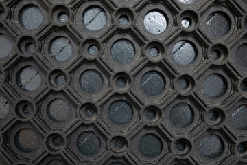 An elevated view of a black rubber doormat