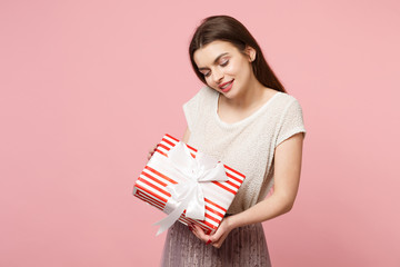 Tender young woman in light clothes posing isolated on pink background. Valentine's Day, Women's...