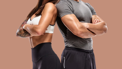 part of Two young athletes posing on brown background