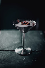 black red coctail in metal blow on black with orange