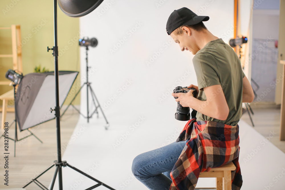 Wall mural teenage photographer in professional studio