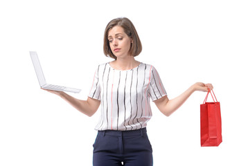 Sad businesswoman with laptop and shopping bag on white background. Concept of balance between work and leisure
