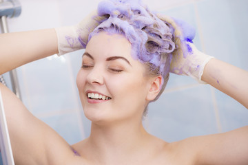 Woman applying toner shampoo on her hair