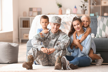 Happy military man with his family at home