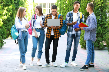 Portrait of young students outdoors