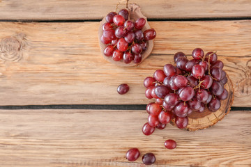 Tasty fresh grapes on wooden background