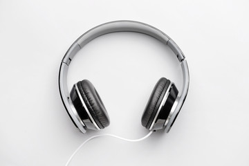 Fototapeta na wymiar Modern headphones on light background