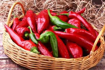 Wicker basket full of fresh red chili peppers.