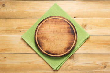 pizza cutting board and naplin at wooden background