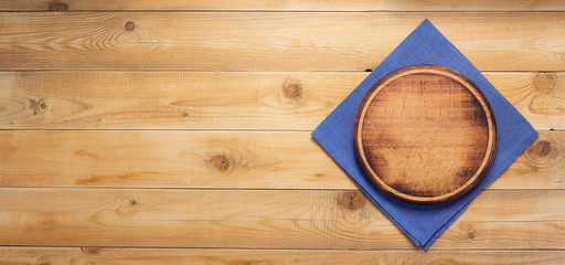 pizza cutting board and naplin at wooden background