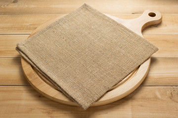 pizza cutting board and napkin at rustic wooden table