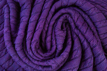 Crumpled  knitted blanket. Soft and warm fabric crumpled in folds. Texture for background or...