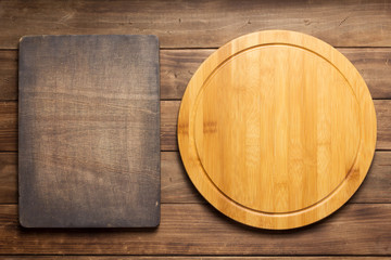 pizza cutting board at wooden plank board background