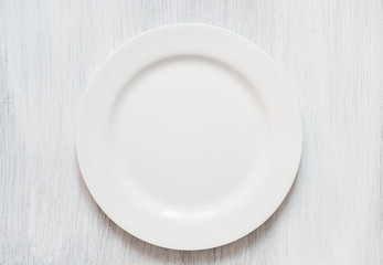 White round plate on white background. Empty white plate on white background.