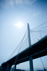 Fototapeta na wymiar transport bridge over the river against the sky