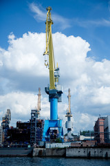 cargo port cranes against blue sky