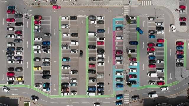 Aerial footage of a busy car park with cars  parking and driving around the car park, located in Doncaster West Yorkshire on a bright sunny day.