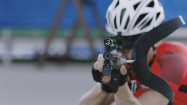 Portrait of Caucasian male professional biathlete practicing on a shooting range during mid-season practice in summer. ARRI Alexa Mini with Cooke S4 prime lenses RAW graded footage