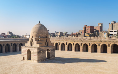 Fototapeta na wymiar Courtyard of Ibn Tulun public historical mosque with ablution fountain and arched passages, Medieval Cairo, Egypt